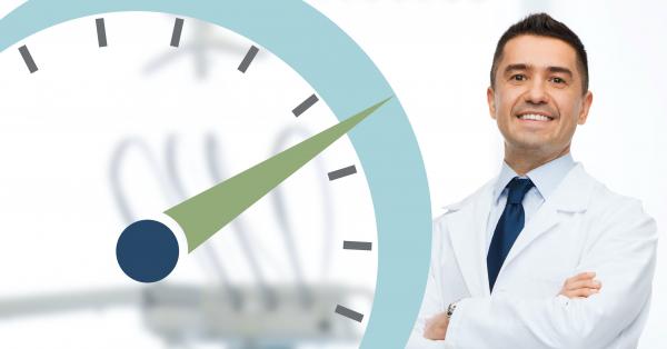 A doctor standing near a stopwatch